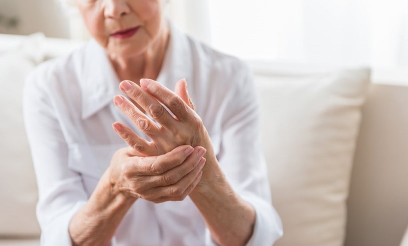 Elderly woman having arthritis pain.
