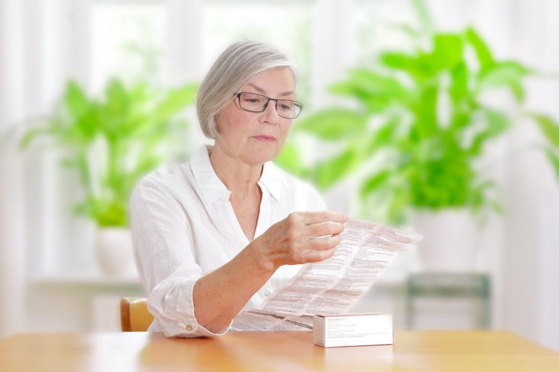 old lady is reading Restoril prescription.