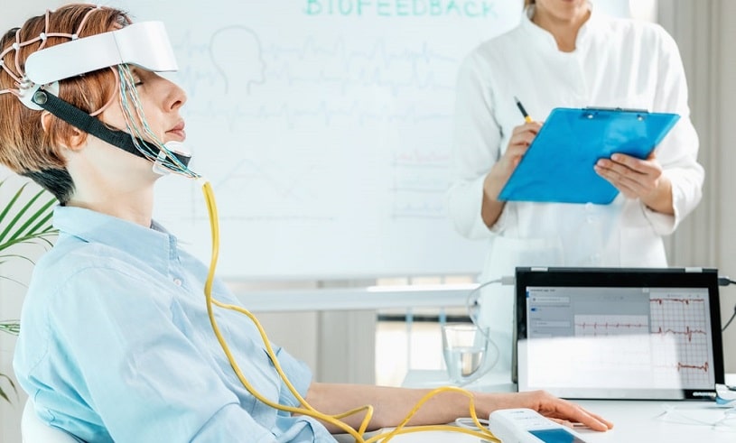 Woman with neurofeedback sensors on her head.