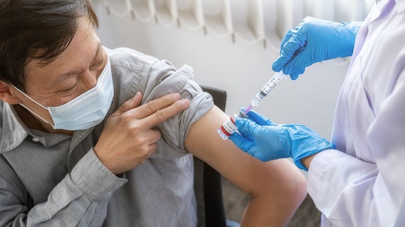 Old man receiving a COVID vaccine.