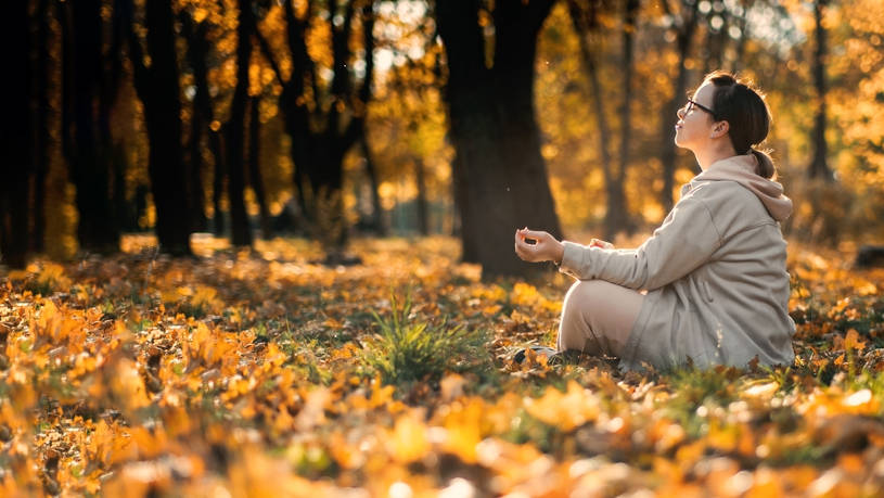 woman meditating in lotus pose in holistic rehab.