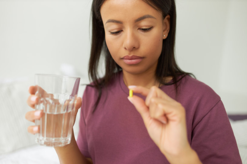 A woman drinks Pristiq pills.