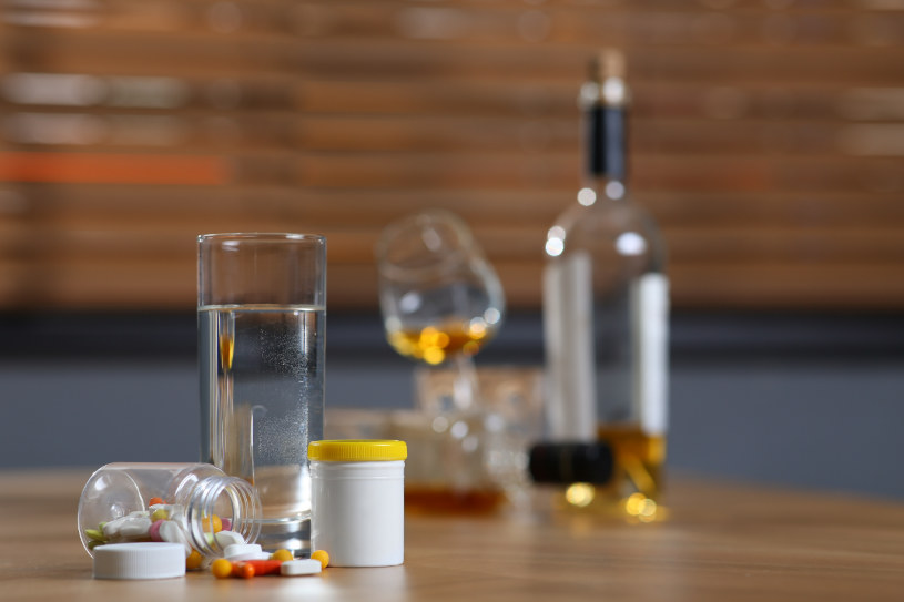 Remeron pills lie on the table with a bottle of alcohol.