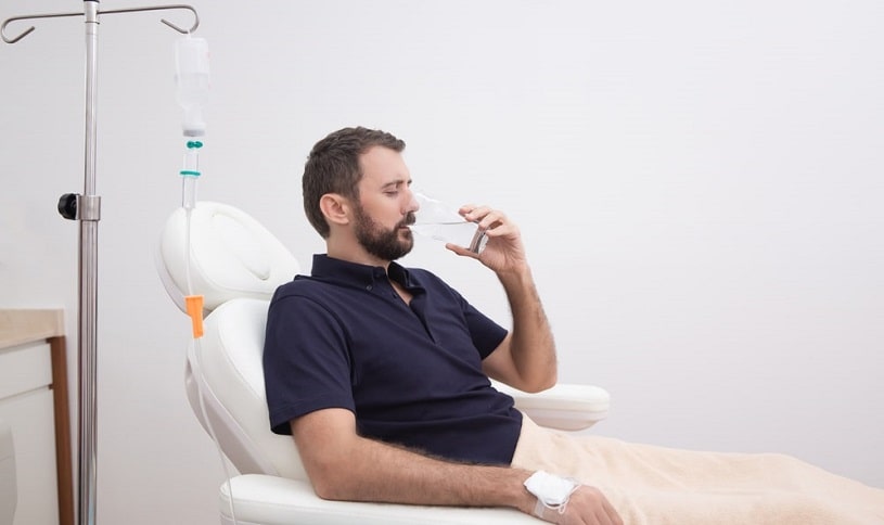 Man receiving NAD IV detox therapy at a center.