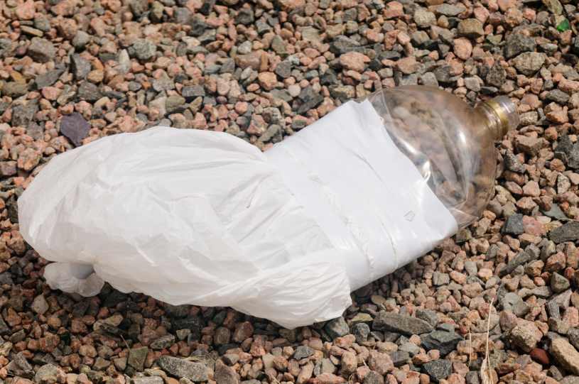 Plastic bag and bottle taped together for glue sniffing.