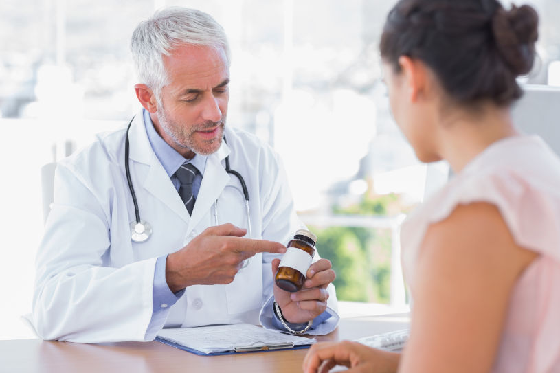 A doctor explains to a patient how to take pills properly.