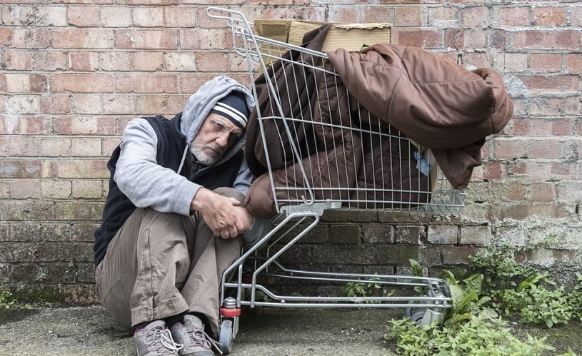 Homeless man sleeping out on the streets.