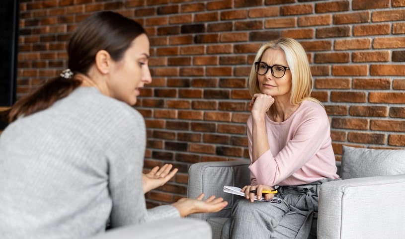 Woman talking to a counselor about addiction.