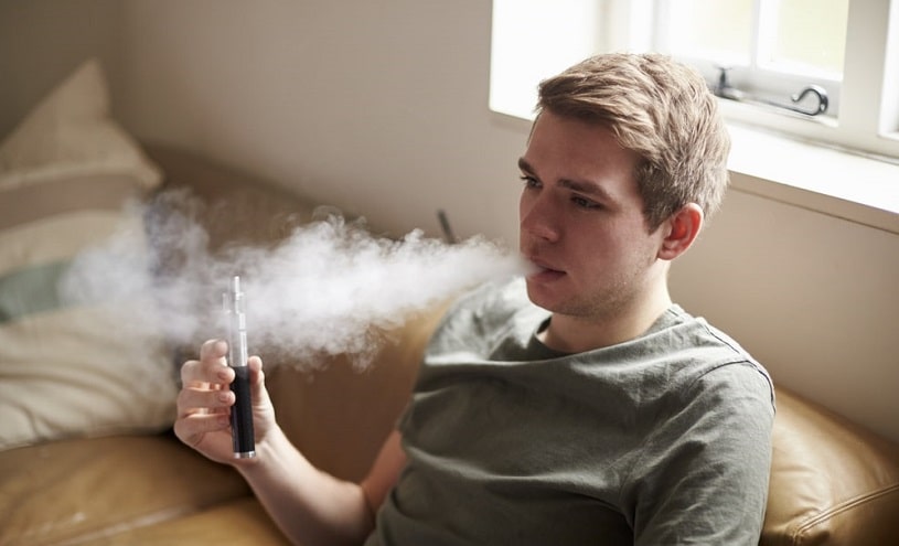 Teenager smoking at home.