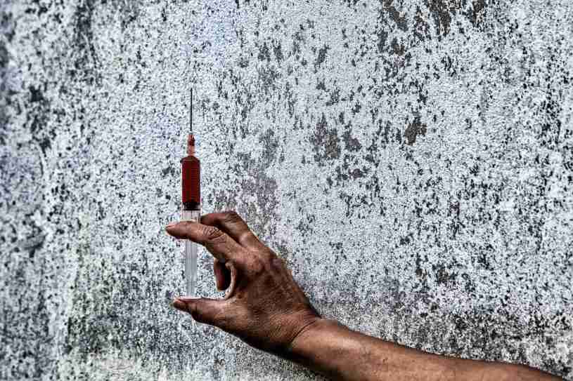 A hand with a krokodil drug in the syringe.