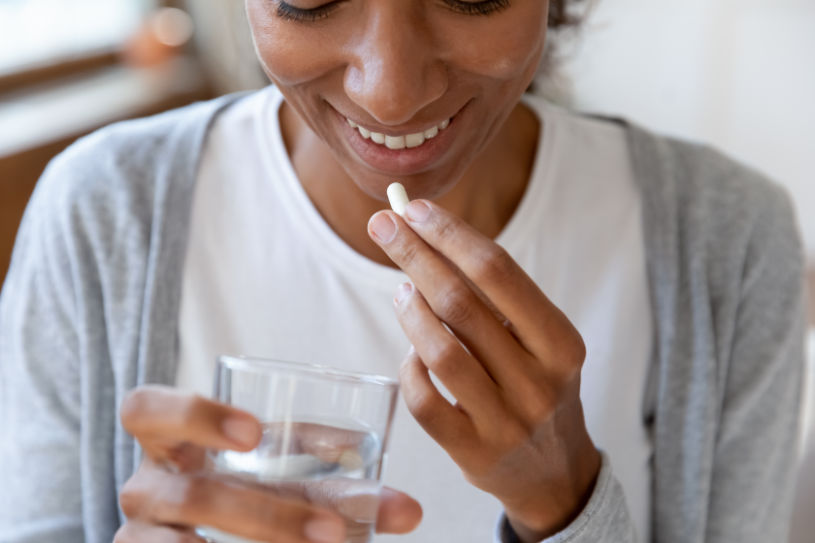A woman drinks buspar pill.