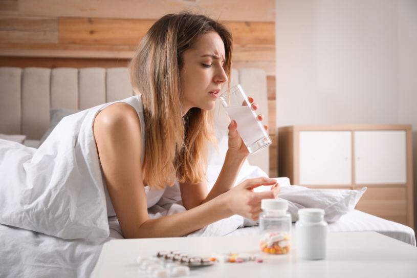 A woman drinks paxil pills.