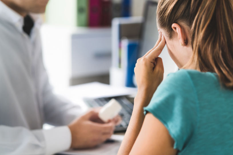 A woman with a severe headache asks a doctor about the antidepressants overdose.