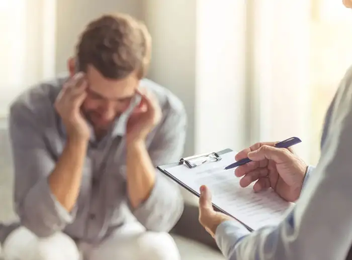 A depress boy filling out a form